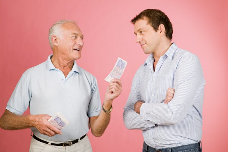Elderly Man Lending Cash Younger Man